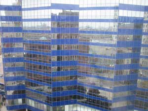 buildings mirrored in windows of buildings